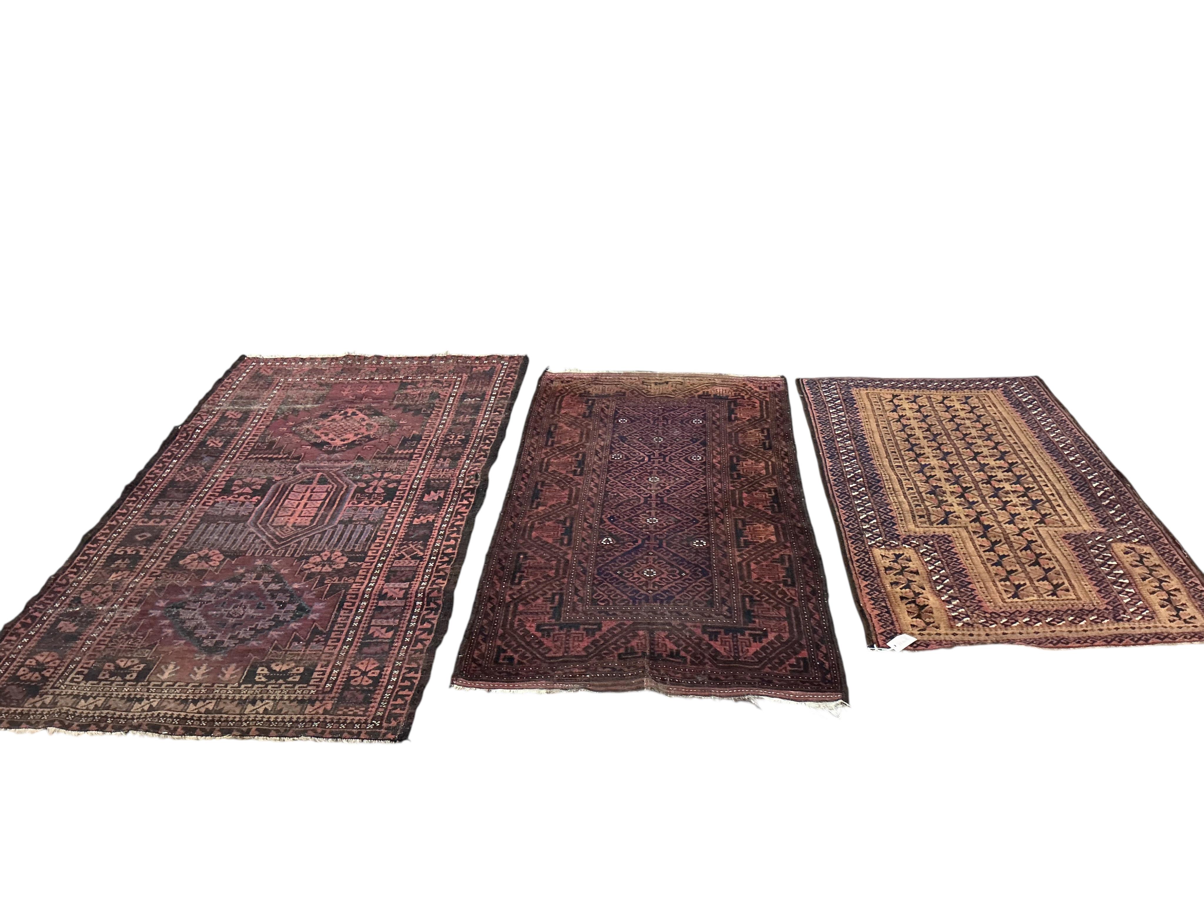 Two Belouch tribal rugs and an Afghan tribal rug, largest 200 x 110cm